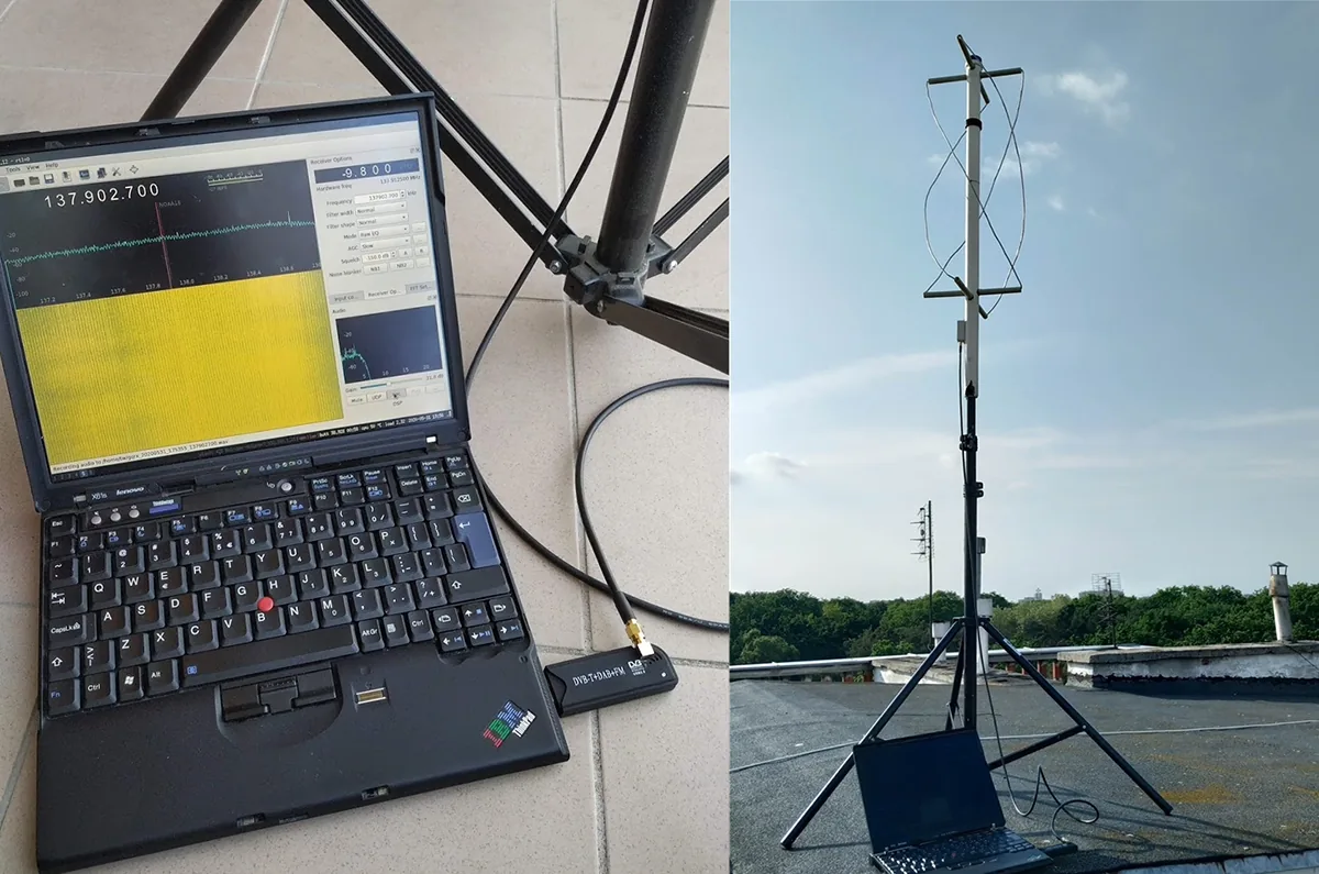 A ThinkPad running Gqrx at 137.9 MHz, a DVB-T dongle used as an SDR receiver and a QFH antenna made of PVC pipe on a tripod on a roof